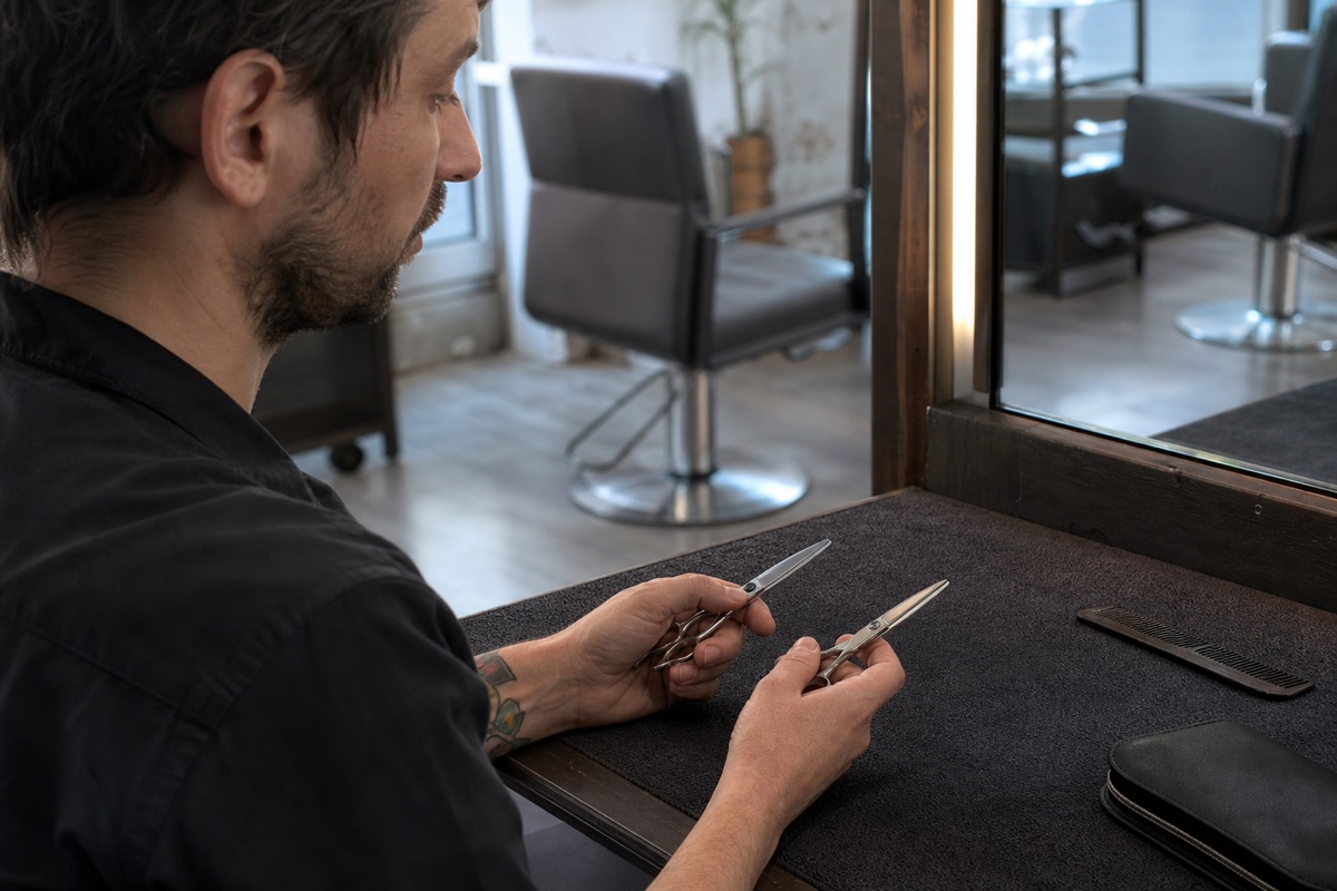 Generated editorial photograph: a working stylist compares two closed unbranded shears at a salon station.