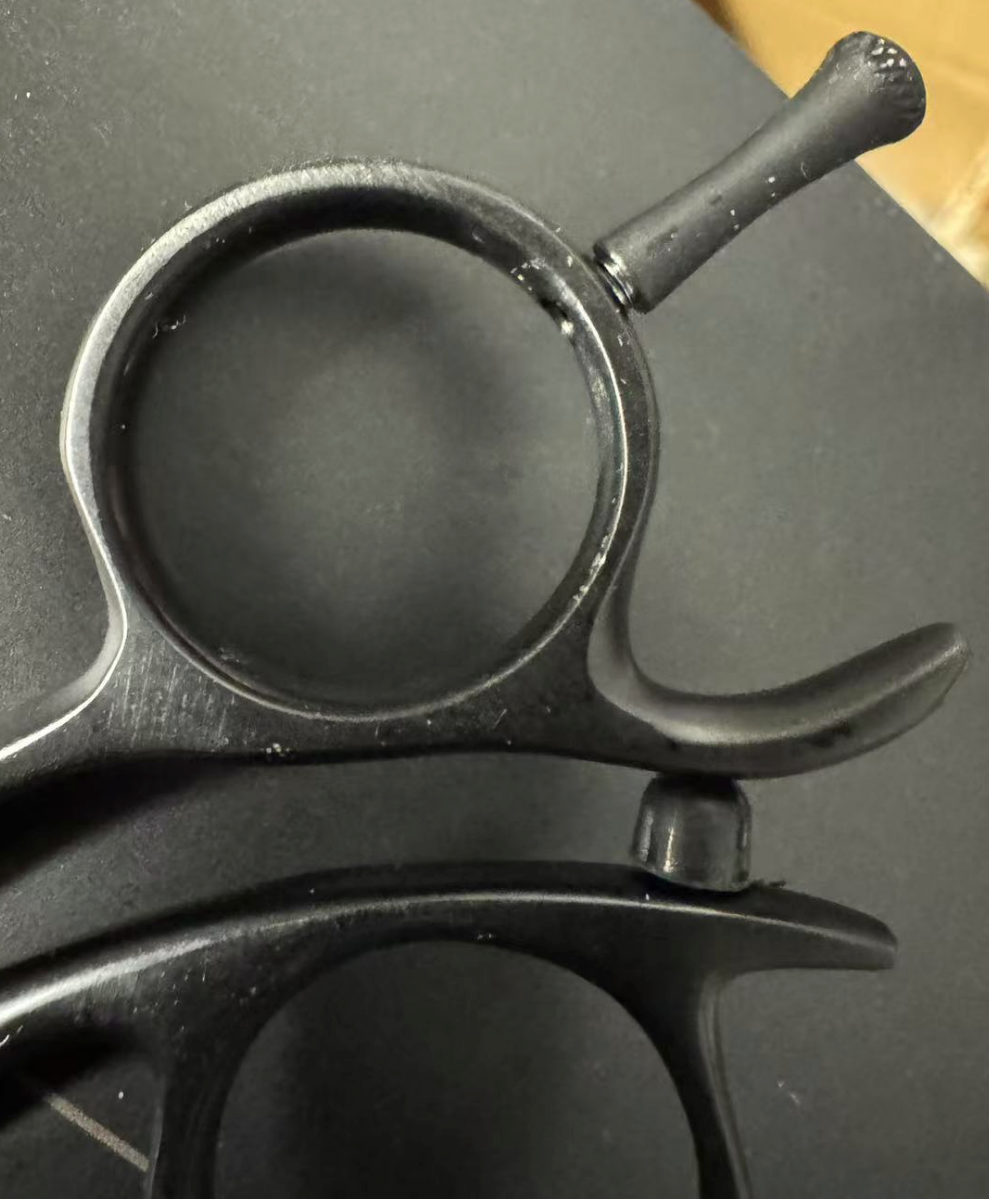 Close-up of scissor ring area showing plating fixture marks and rough surface finishing