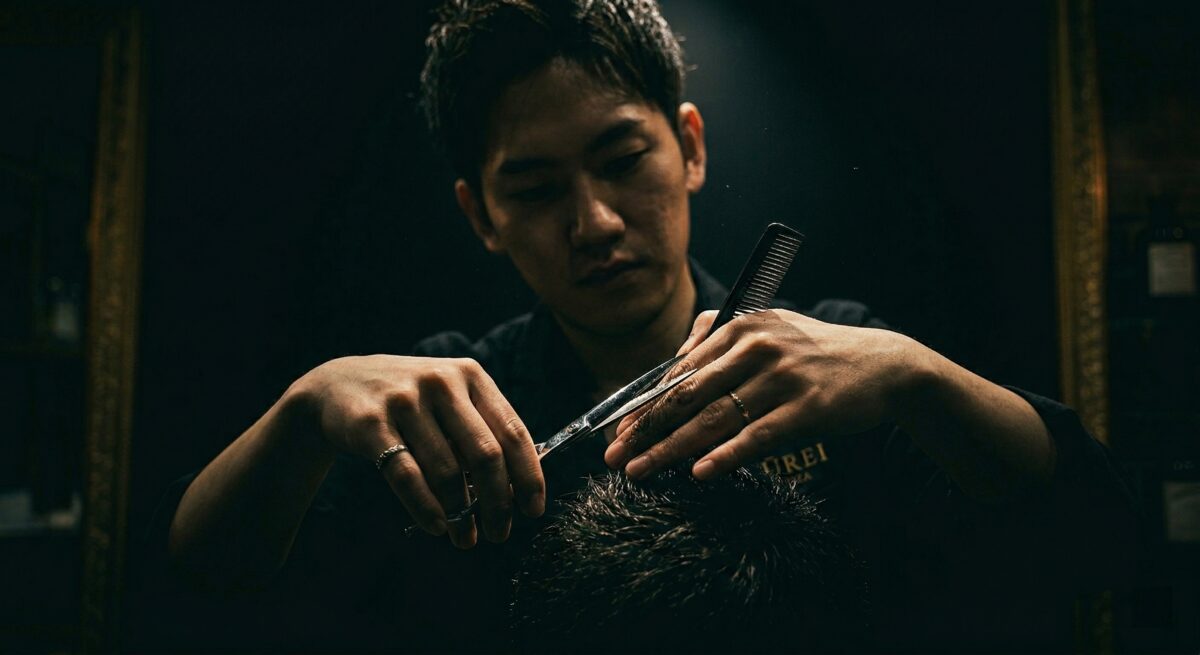 Stylist hands holding scissors in an ergonomic cutting position