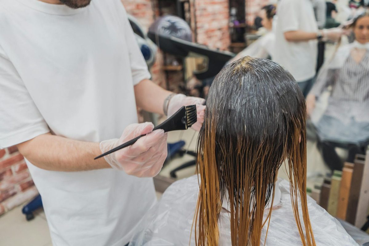 Salon professional performing hair cutting technique
