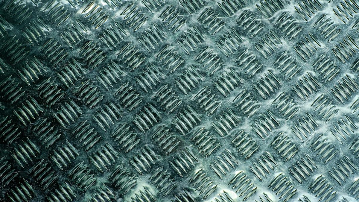 Steel metal texture closeup — VG-10 and cobalt alloy look similar but perform very differently in professional scissors