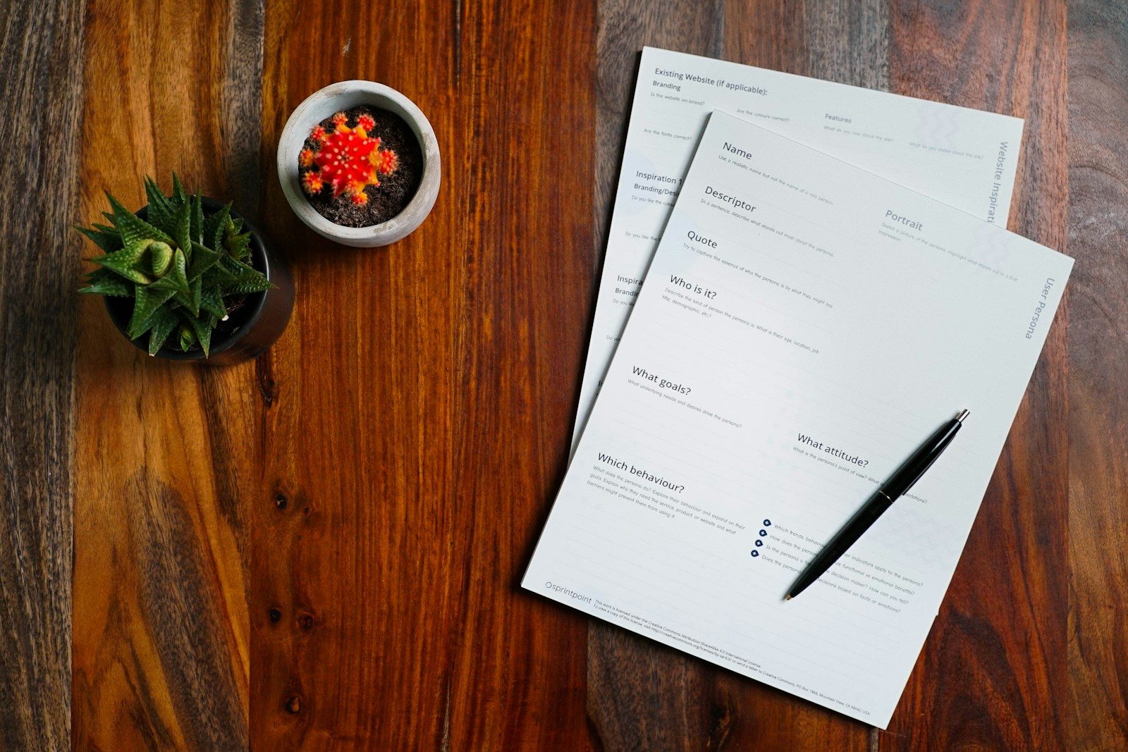 Insurance paperwork with pen and notepad on a wooden table