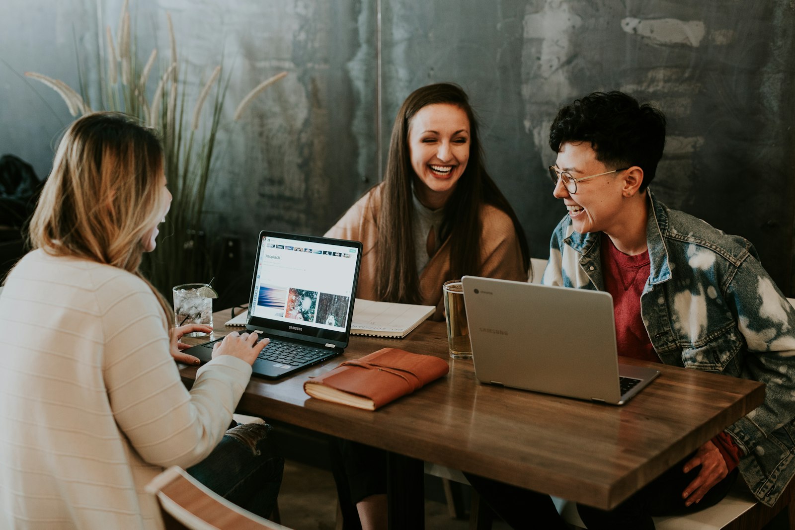 Stylists building a training roadmap with laptops and notebooks