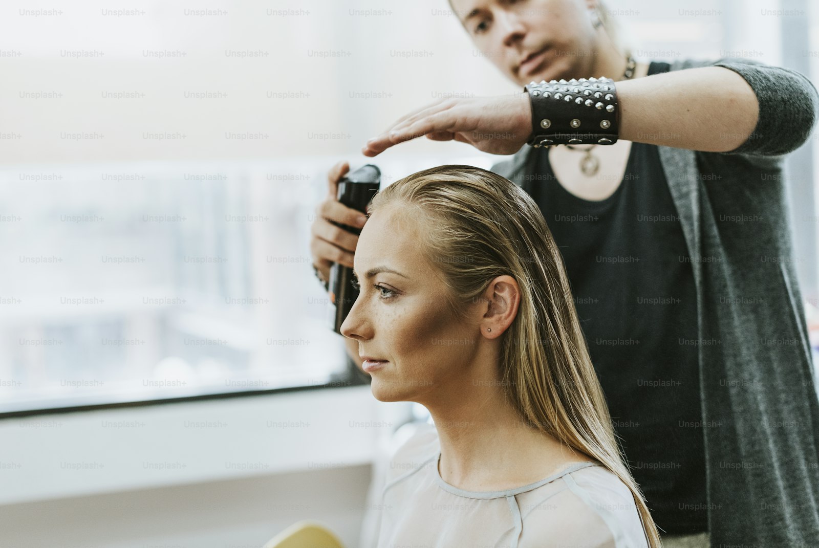 Stylist prepping a model backstage before a competition