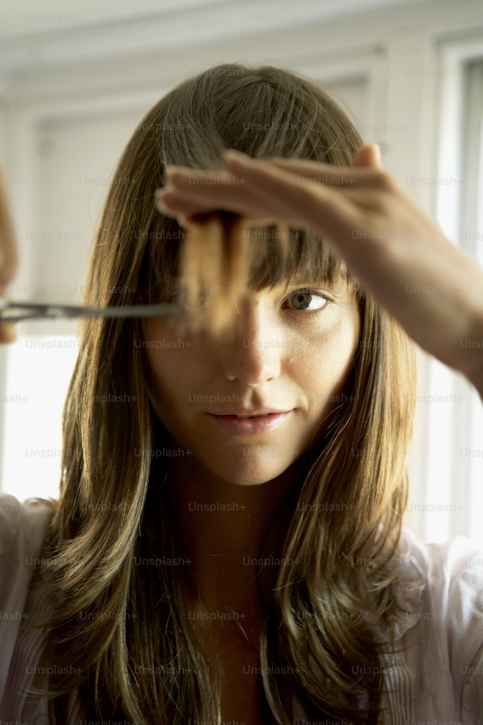 Precision stylist cutting a sharp bob with shears