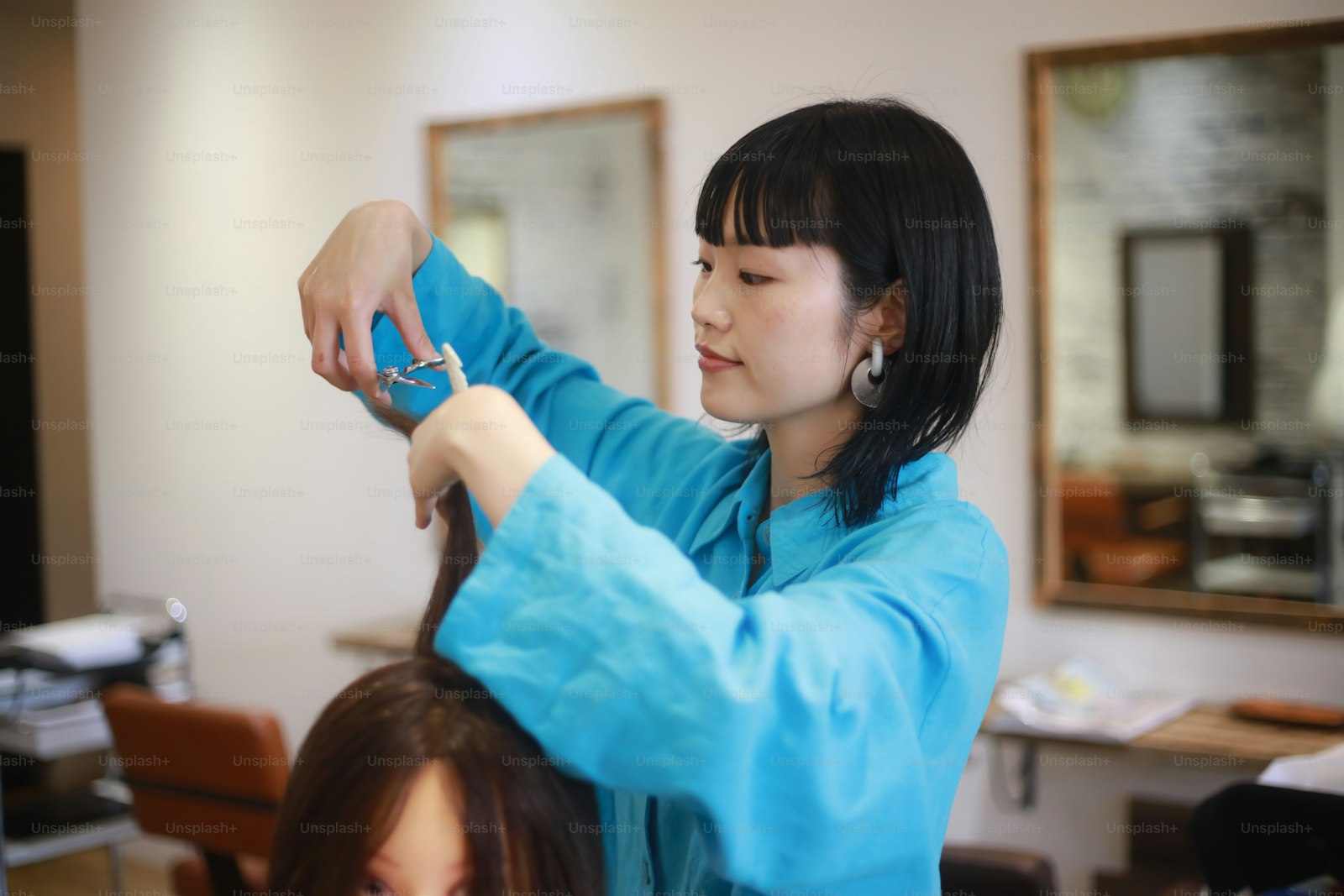 Stylist practicing haircut techniques during a salon training session