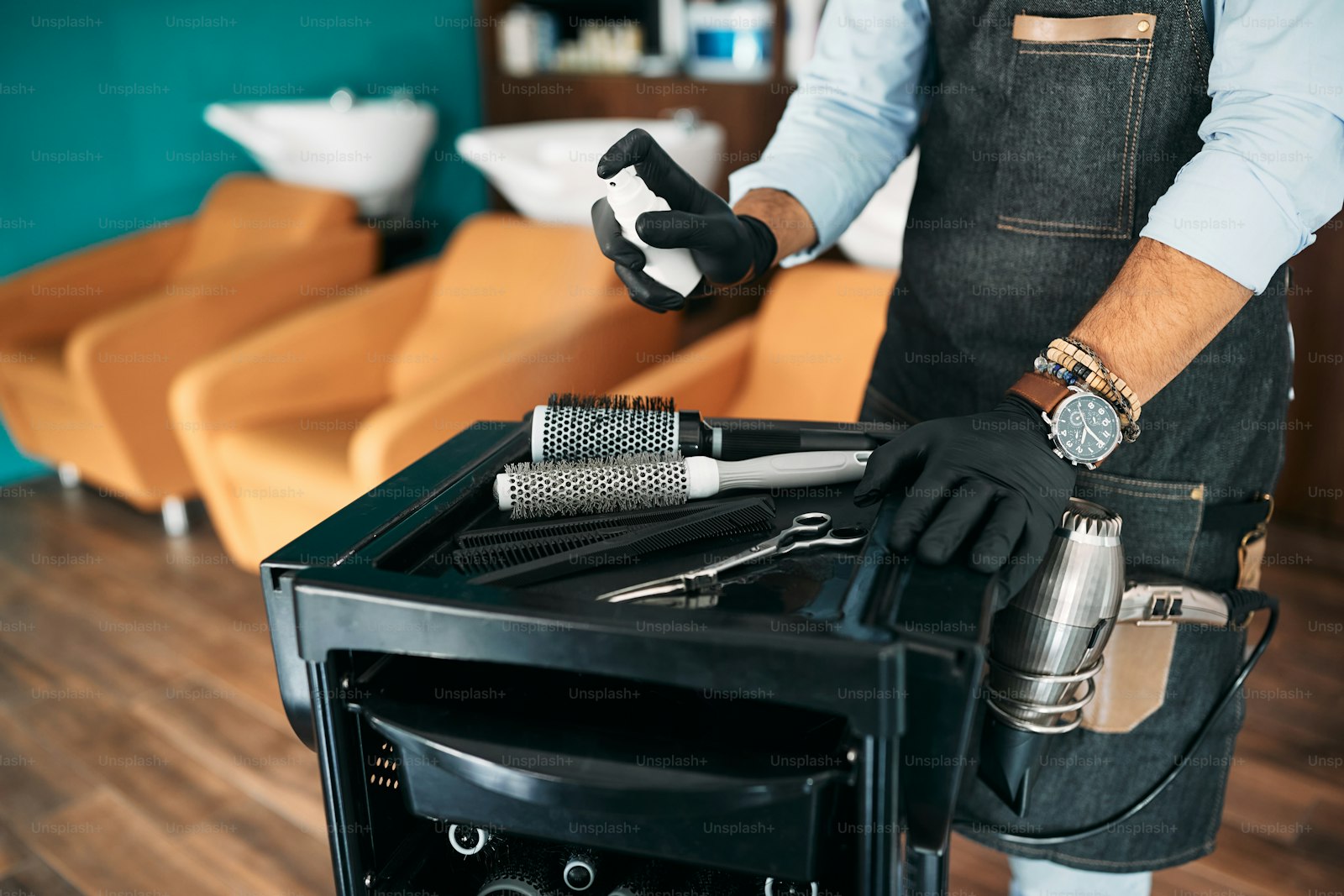 Stylist sanitizing shears and tools at the end of the day