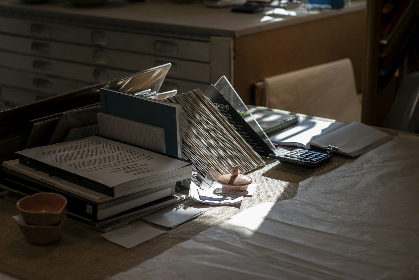 Budget paperwork with calculator and notebooks on a desk