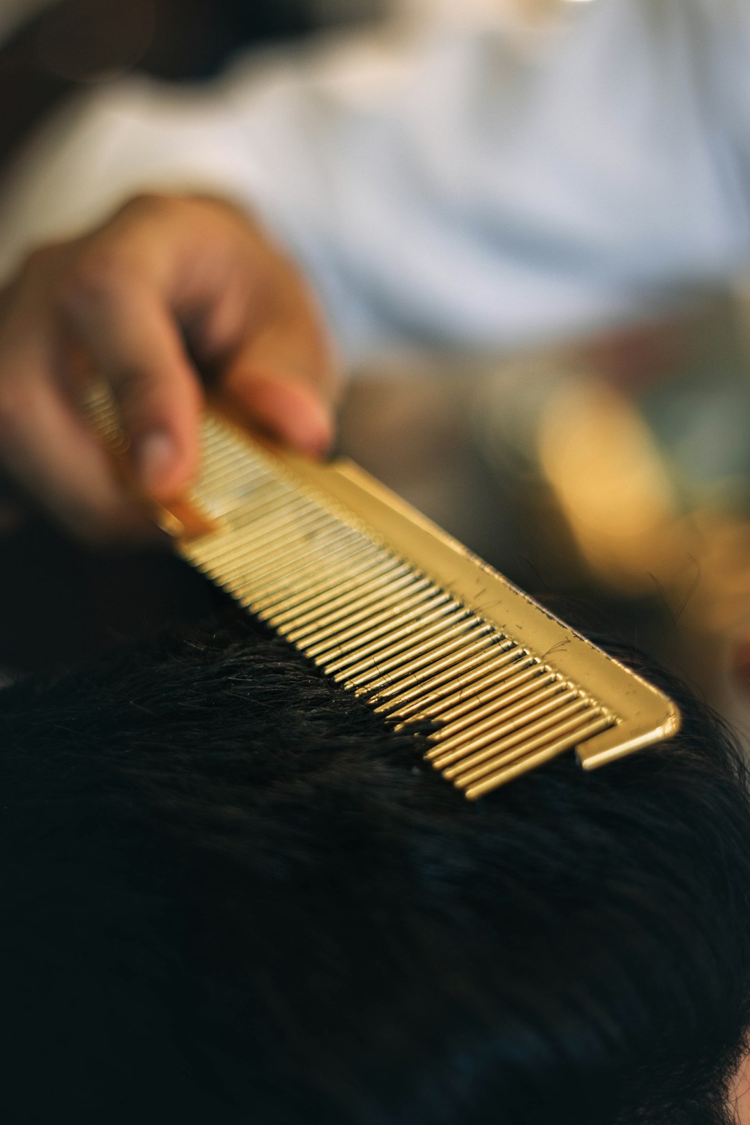 Close-up of shear-over-comb on short hair