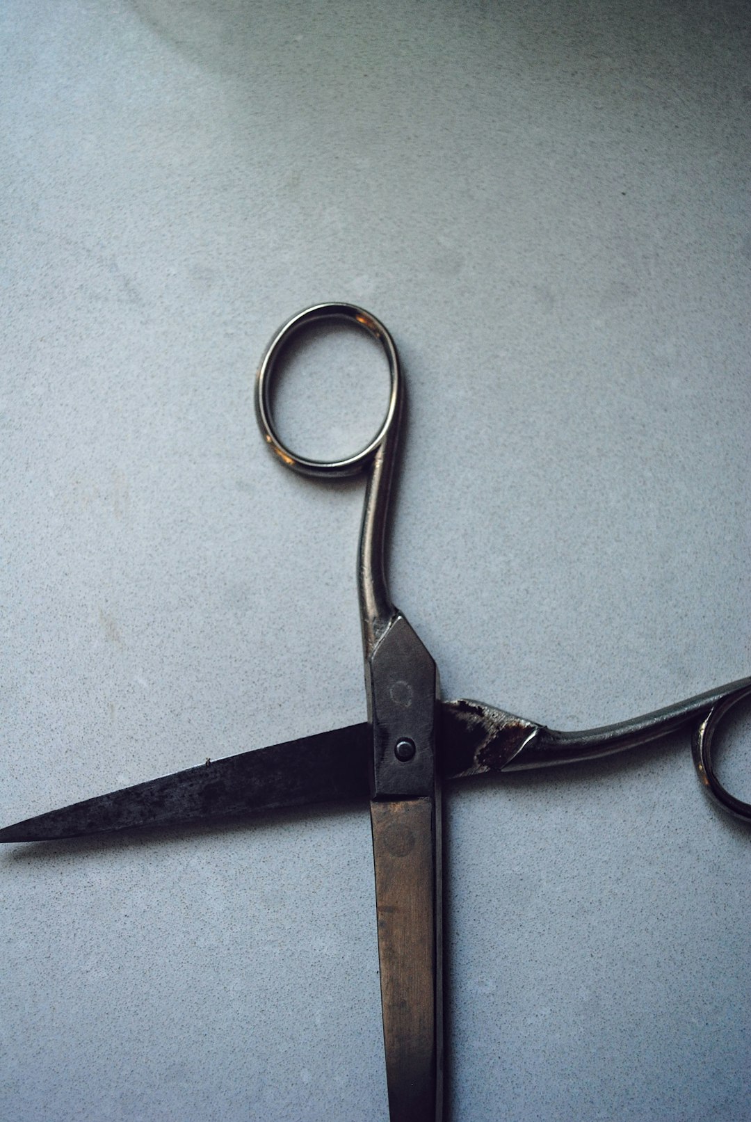 Person attempting to sharpen hair shears at home with a handheld tool