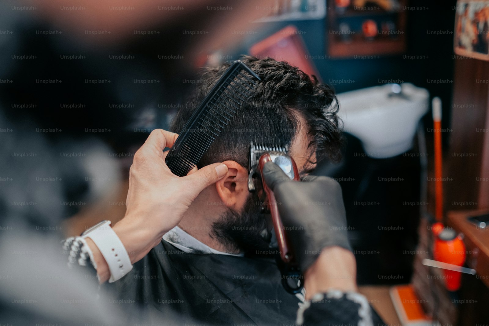 Barber refining a fade on a client with textured hair
